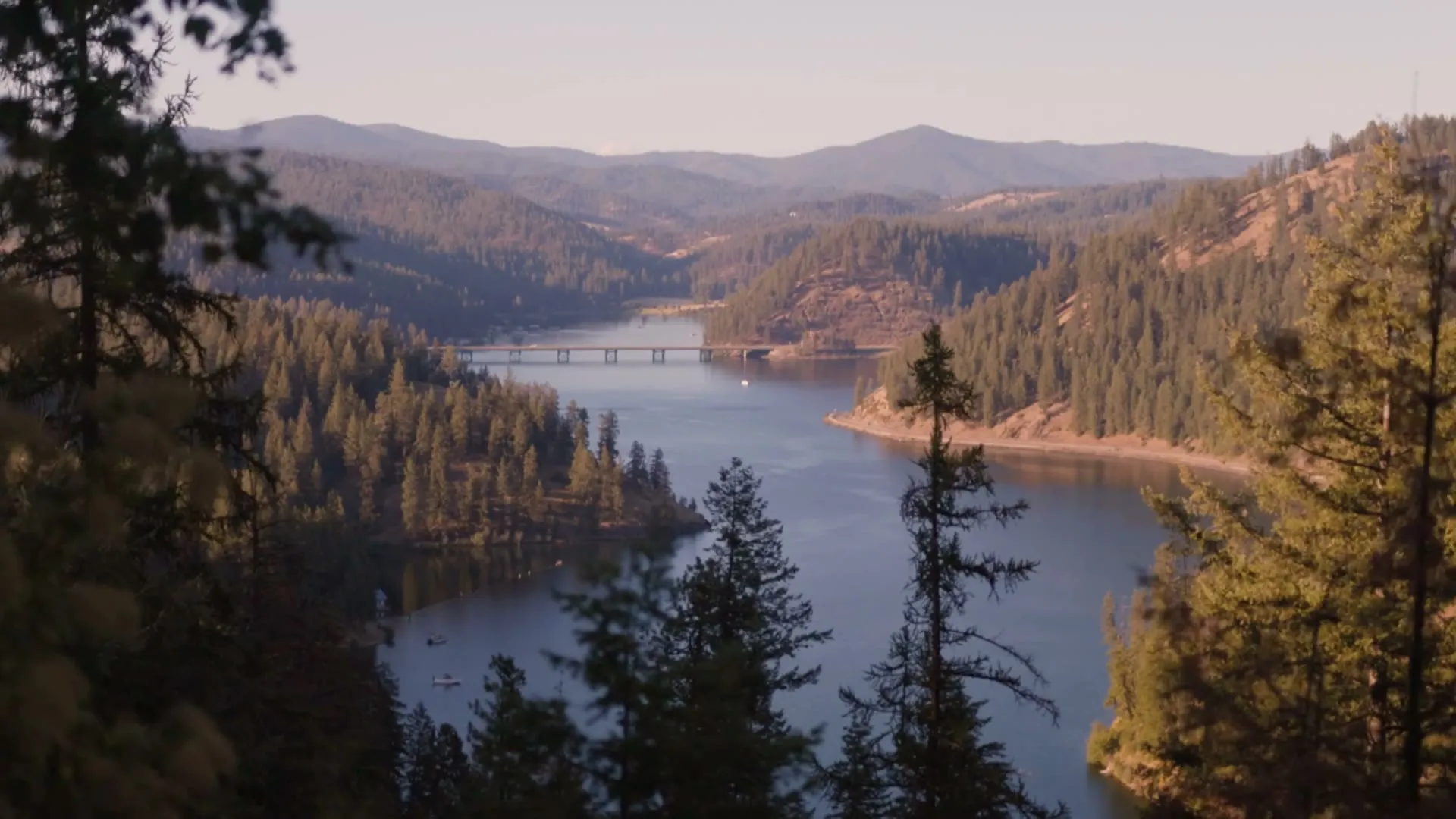 Lake Coeur d'Alene and the surrounding forested hills at golden hour